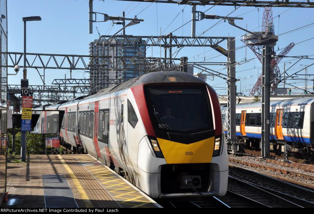 Outbound EMU's come into the station past another